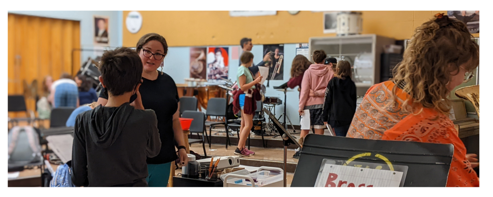 Teachers and students in the Music Room with instruments