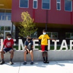 Wing Luke building with three students