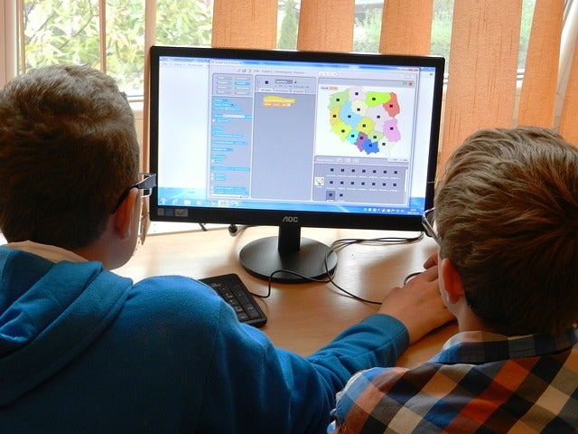 Students sitting at a computer