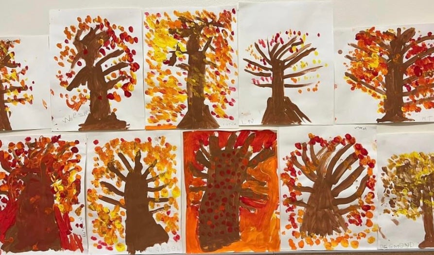 Finger paintings of trees with leaves.