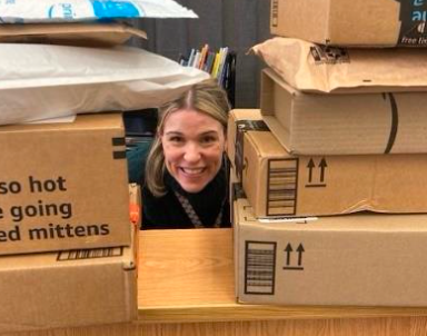 Teacher look through a shelf of books