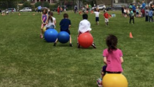 Field with students on large bouncy balls