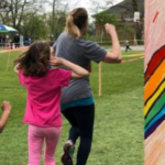Collage students running in the grass and a rainbow with a Dragon drawing