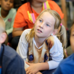 Students sitting on the floor in class