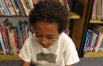 student reading book in library