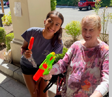 Image of Bluebird student assisting an elder