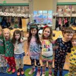 adams students wearing pajamas, lined up with arms on each other's shoulders