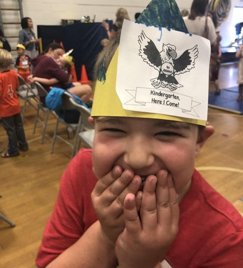 student at Jump Start wearing a crown that says kindergarten here I come!