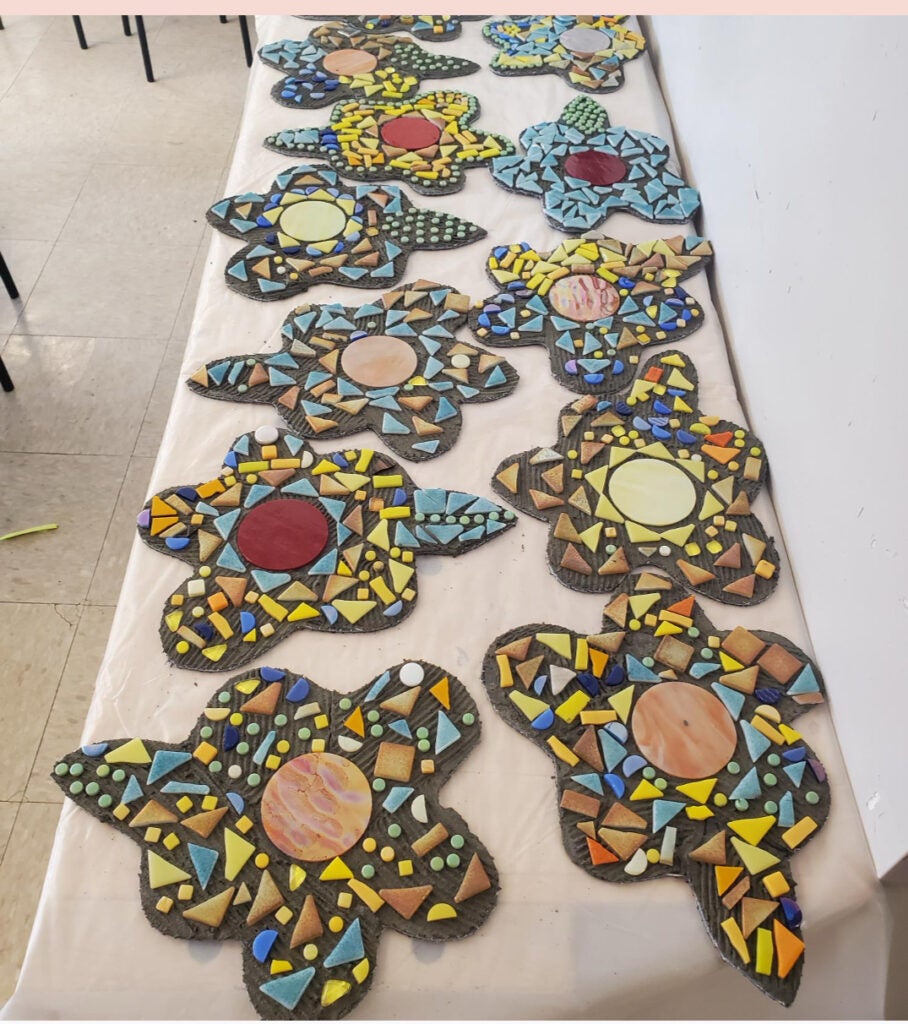 Student-made flower shaped mosaic tiles.