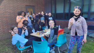students hanging out around a table