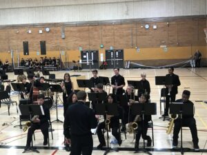students in black shirts playing instruments
