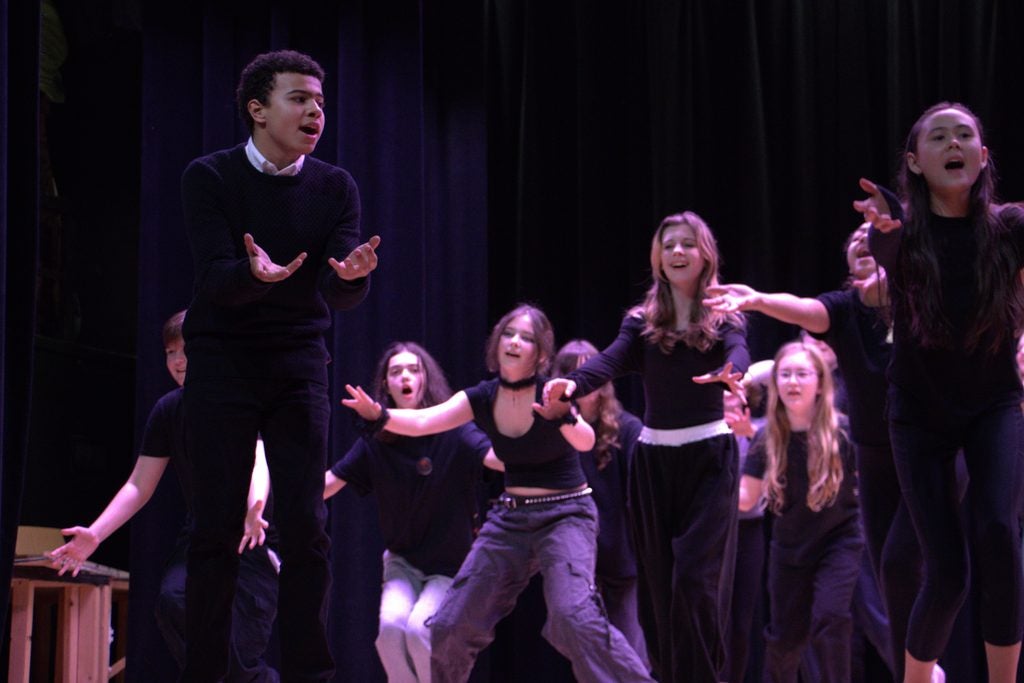students singing on a stage