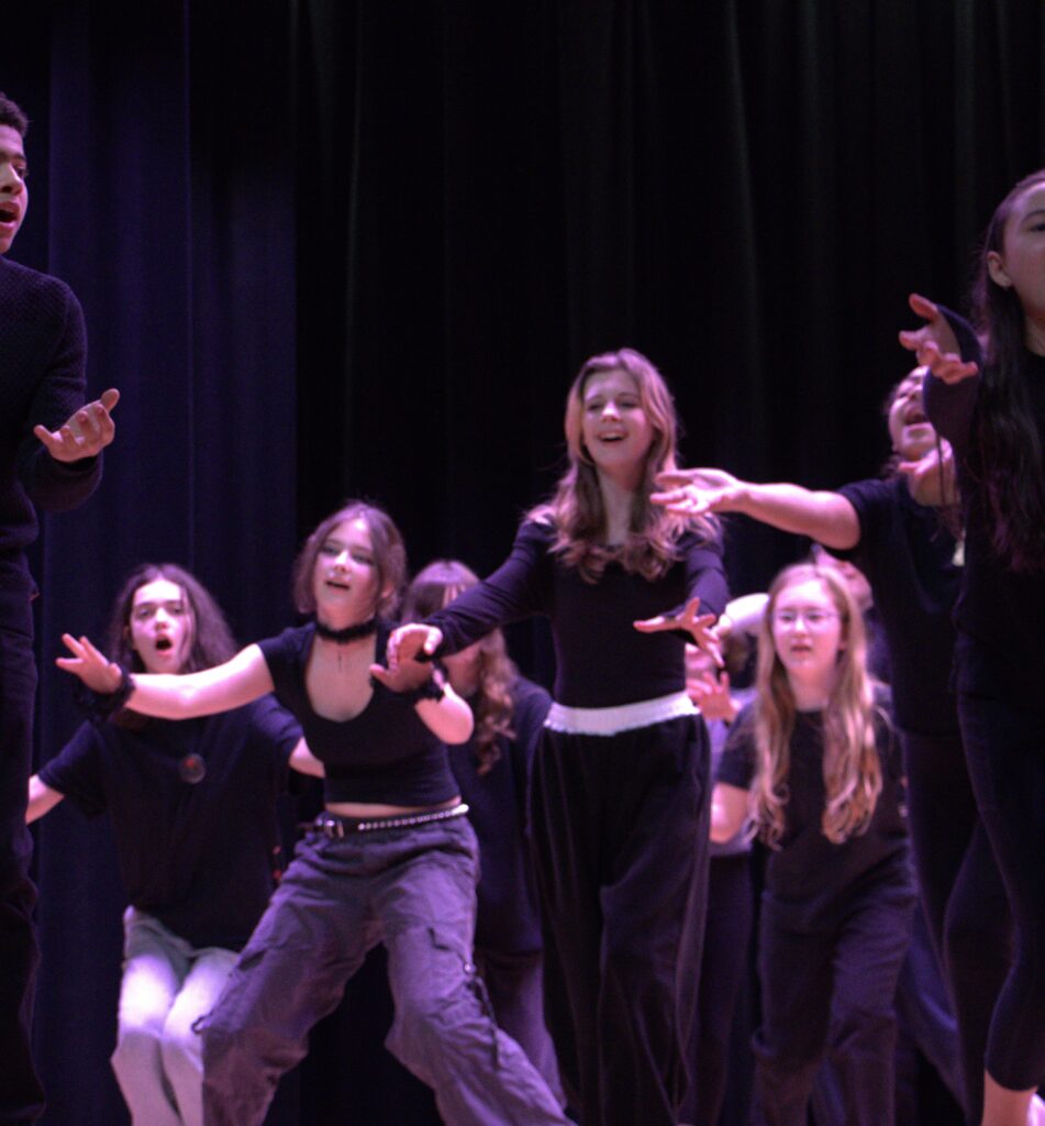 students singing on a stage