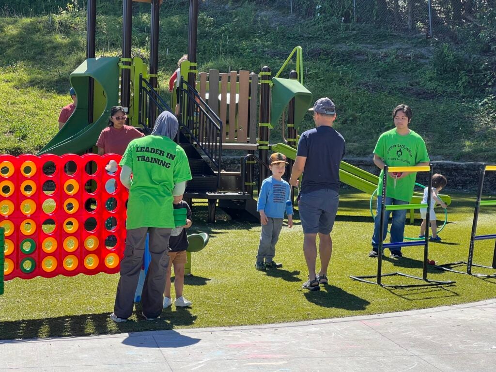 staff at a park playing giant connect four game