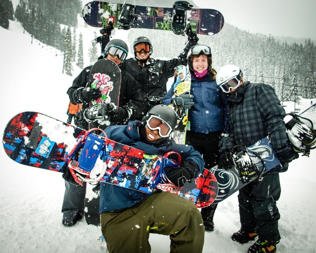 Service Board team with students playing in the snow