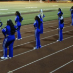 Cheer students lined up on the field.