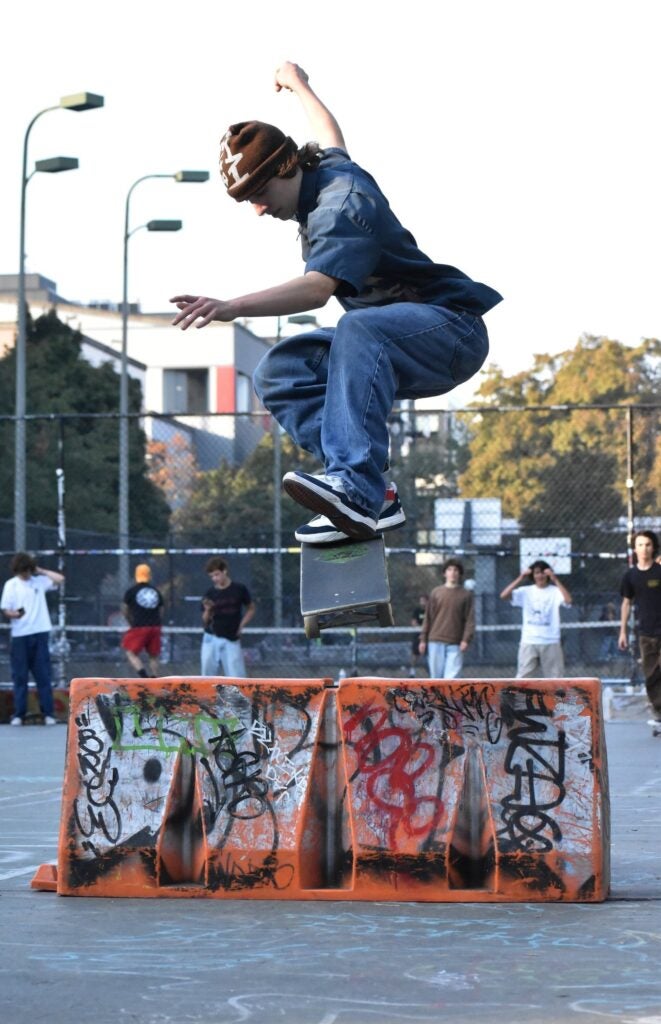 Skateboard rider jumping over obstacle 