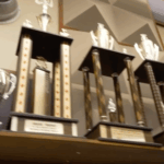 Banner of awards and trophies on a shelf