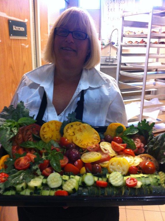 chef holding a platter of vegetables