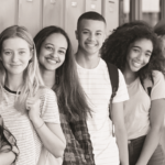 group of students standing by lockers and smiling