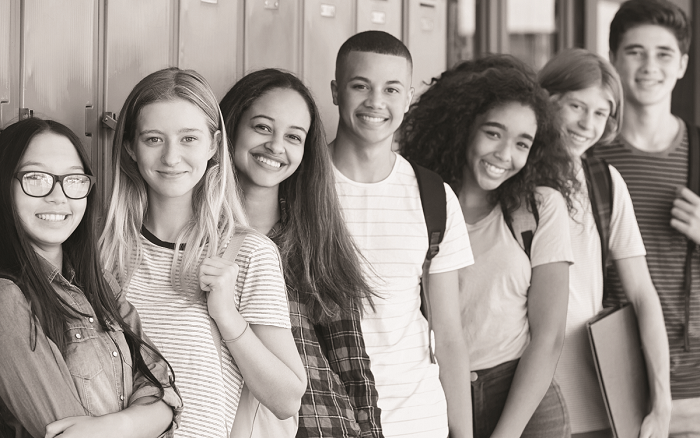 group of students standing by lockers and smiling