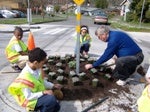 Students and teacher planting flowers