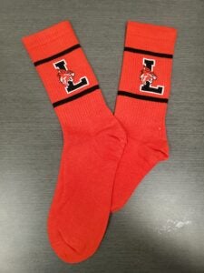 Red socks with black stripe and the Lincoln logo L