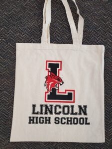 Beige tote bag with Lincoln logo L and the words lincoln high school