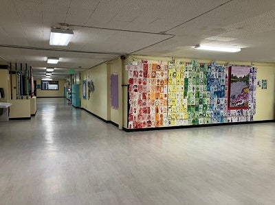 hallway at lowell with student self-portraits