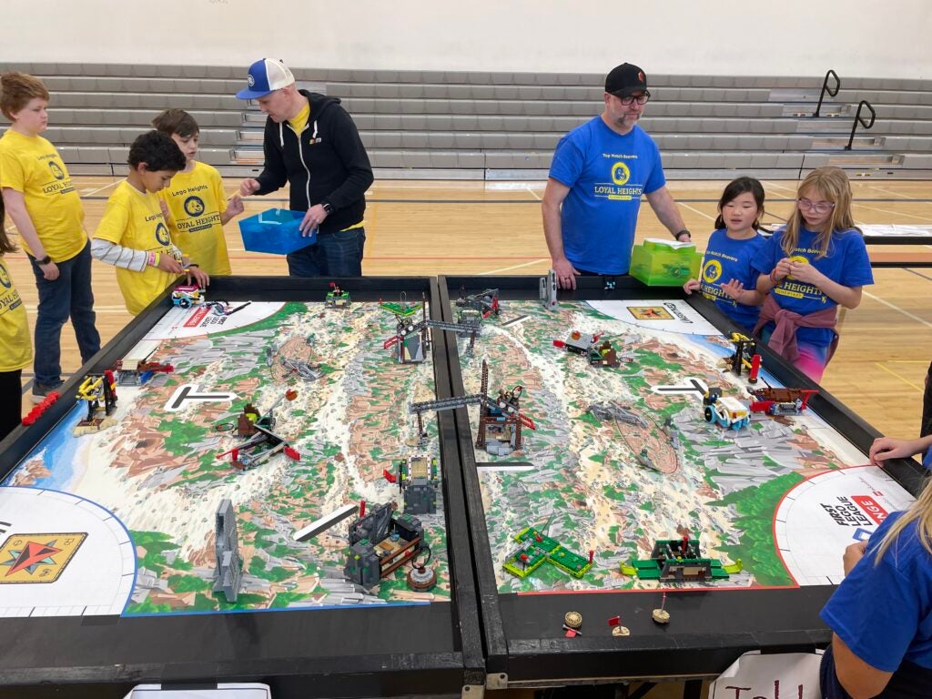kids around a display about robotics