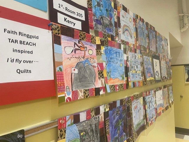 Wall view of many mixed media image of a quilt based on book by Faith Ringgold