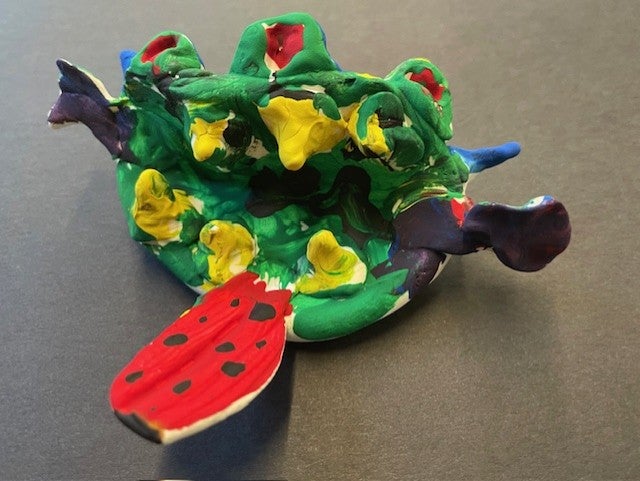 head of a "creature" made of clay