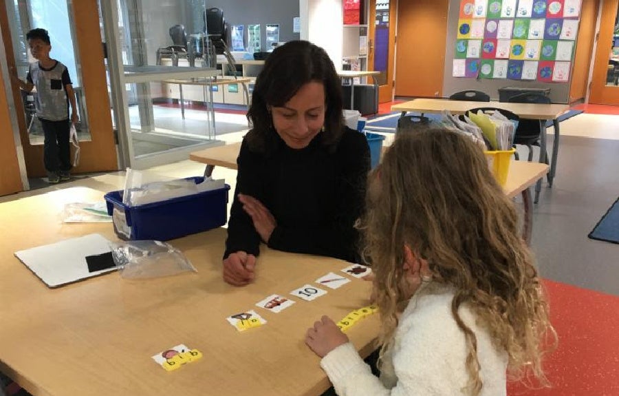 reading tutor working with student