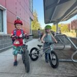 Two students on bikes at school