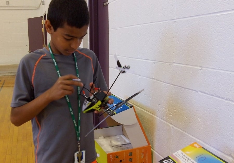 student working on a remote control helicopter