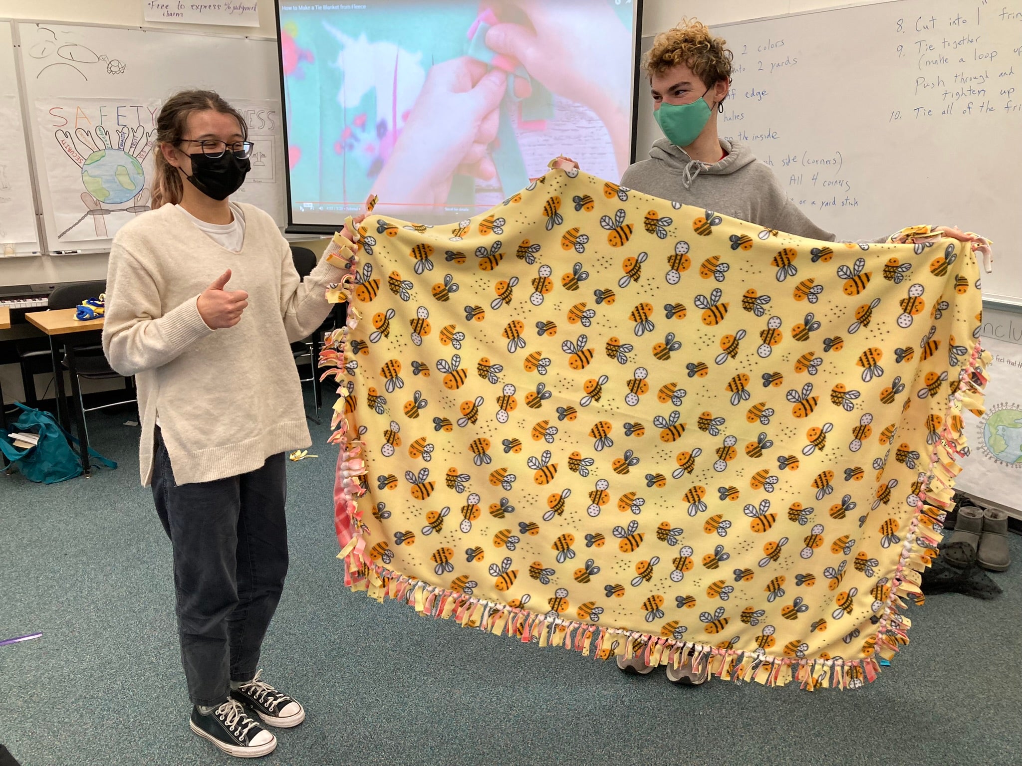 Students holding up blanket