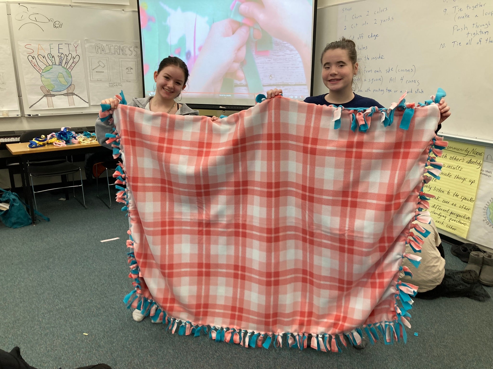 Students holding up blanket