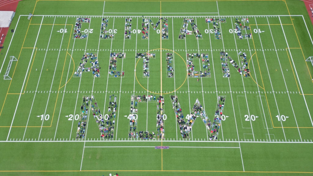 Photo of Nathan Hale HS students and staff on football field spelling out the phrase: Climate Action Now.