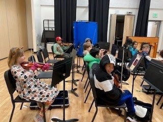 students playing instruments in music class