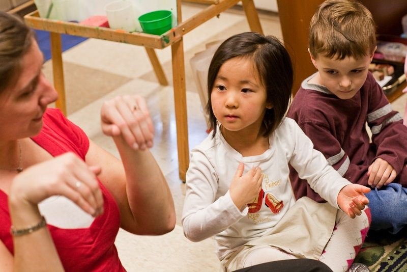 teacher moving hands and 2 students