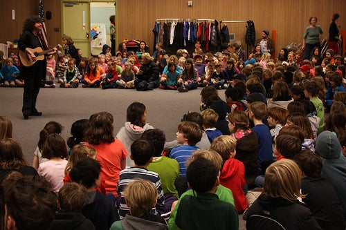 students sitting in a circle in an auditorium