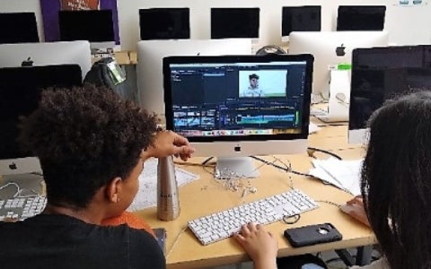 2 students sitting at a computer and editing a video in media arts class at Nova high school