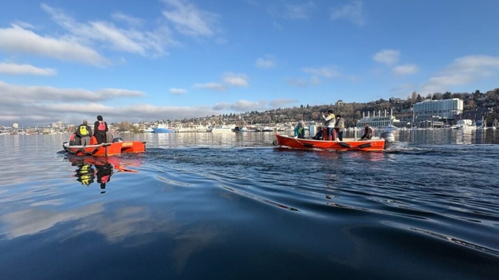 Two boats with students and instructors on lake union on sunny day