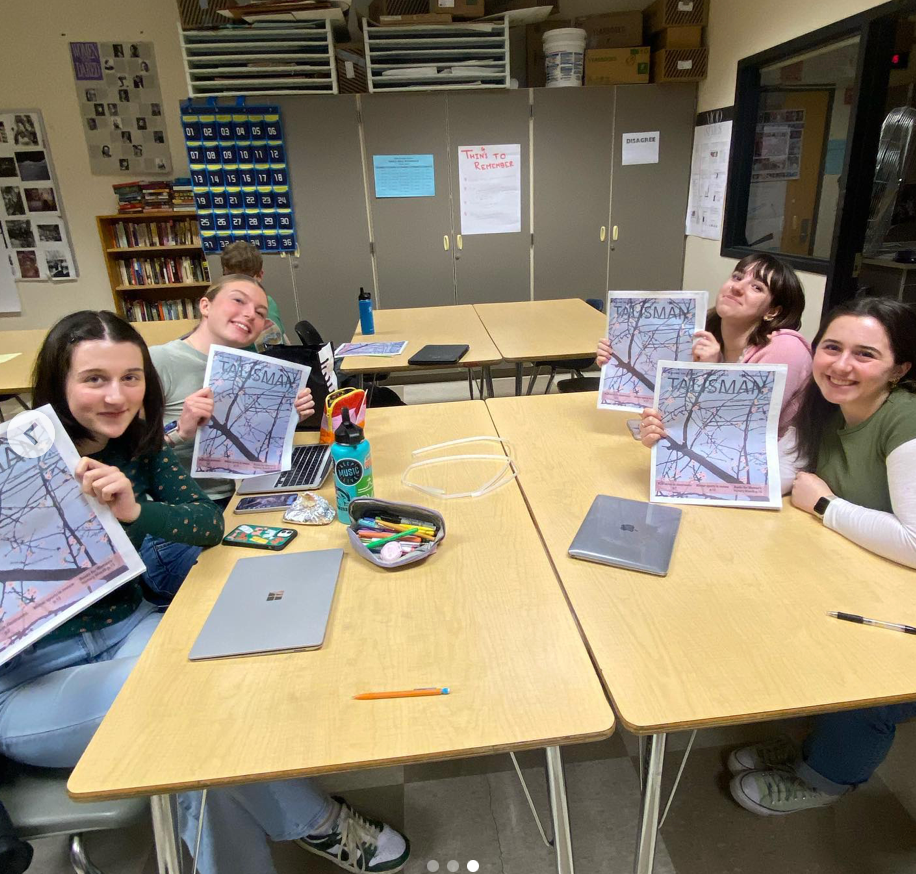 Talisman editors at a table with copy of the Talisman student newspaper