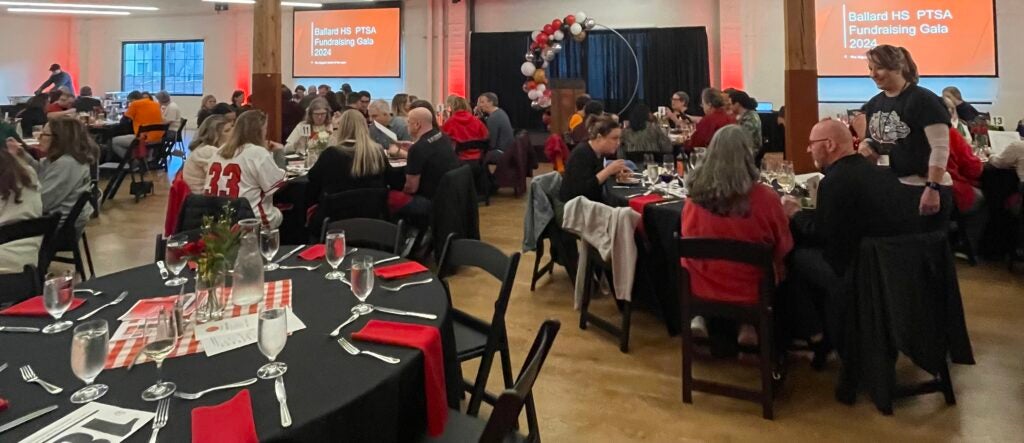 Tables and chairs and parents at Gala Dinner Event.