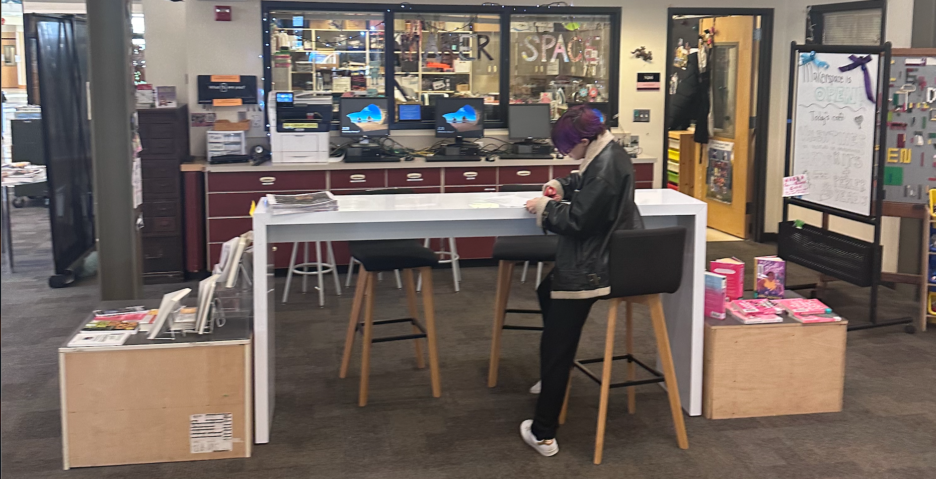 Student working at a table in the library.
