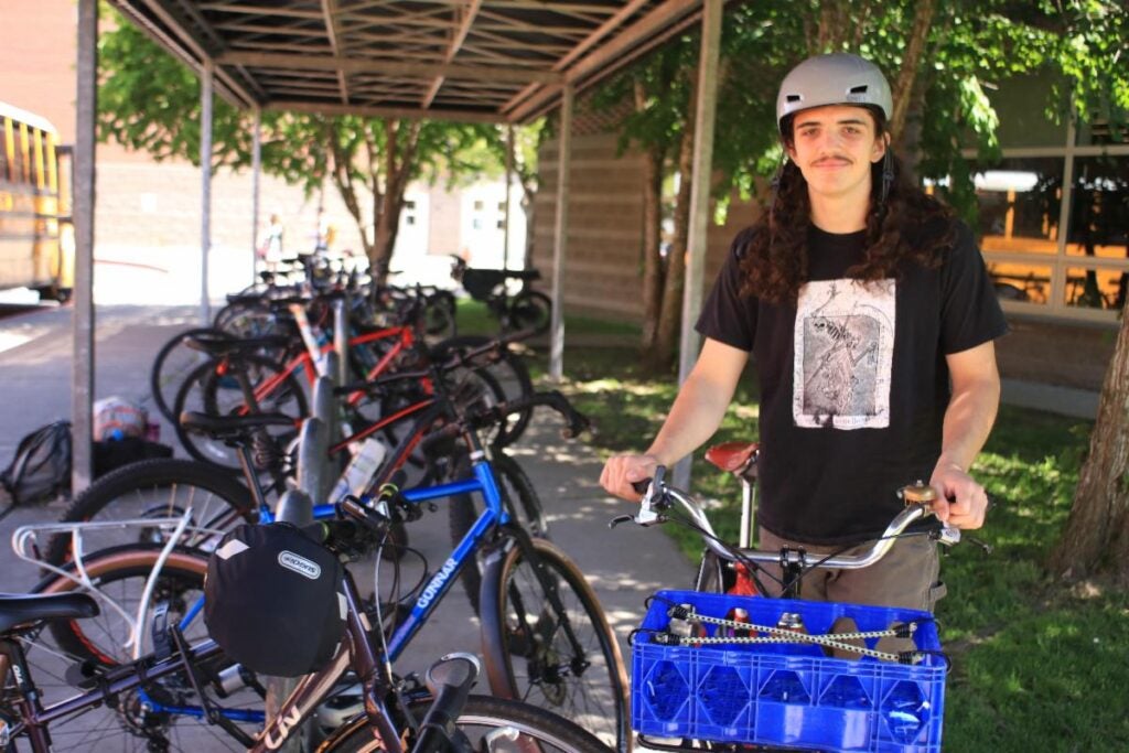 Student with Bikes in Times article. Photo by Matthew W.