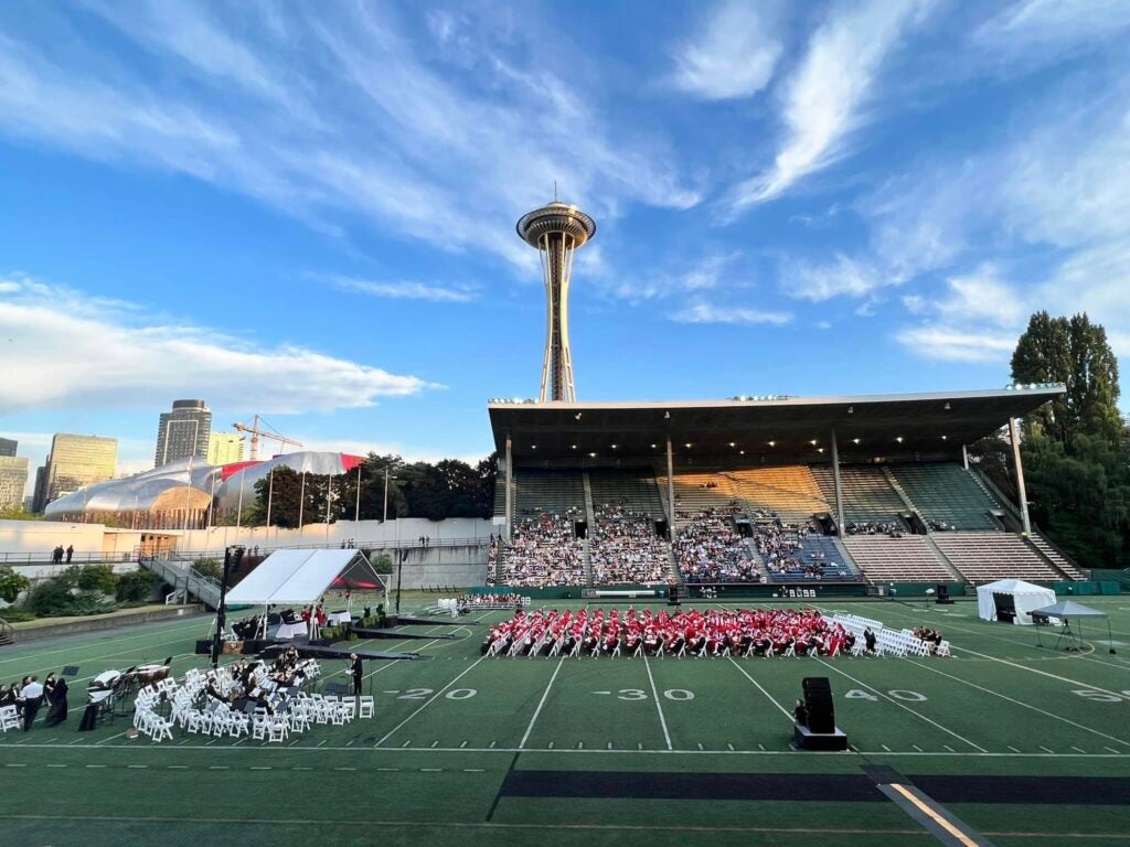 Graduates on field at Memorial Stadium. Photo Credit Rachel Hart Rios