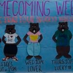 Poster hanging in Commons with Beavers dressed up for each day of the week spirit.