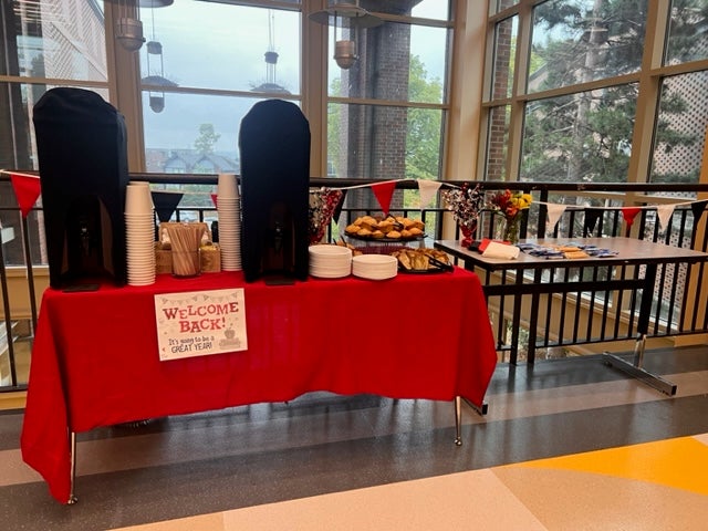 Tables in the hallway welcoming back staff with lunch items.